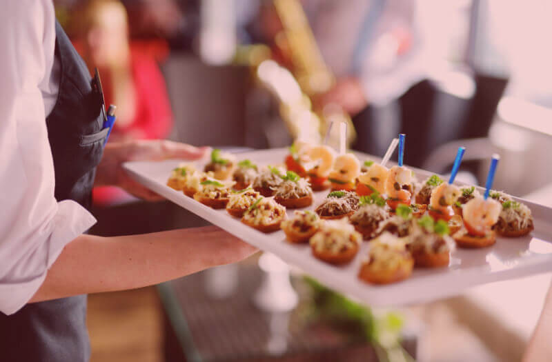 Canapés  being passed on a tray 